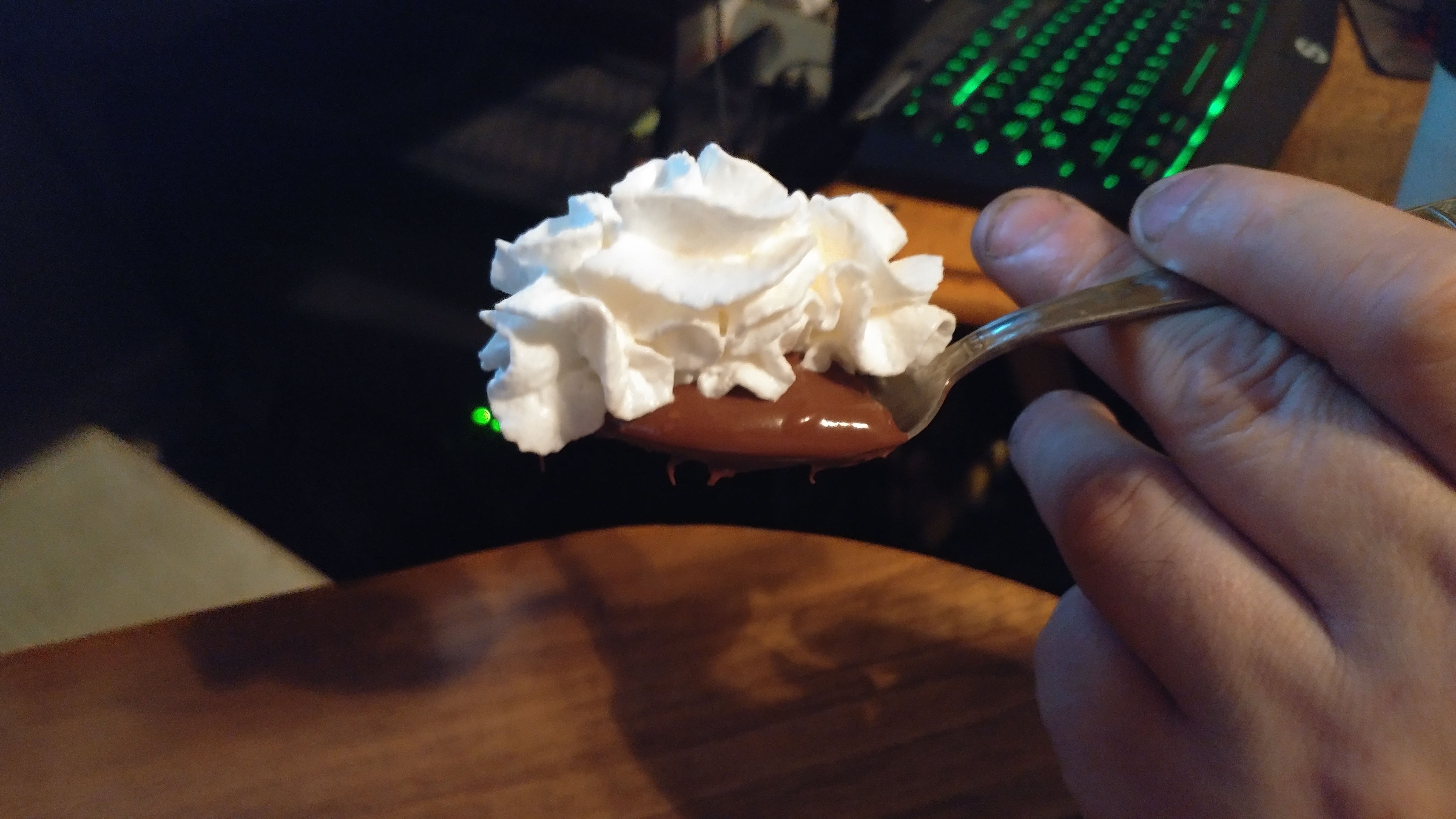 A spoon full of Nutella and Whipped Cream